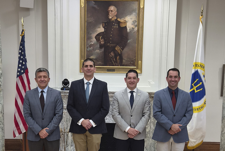 Four men in front of a painting